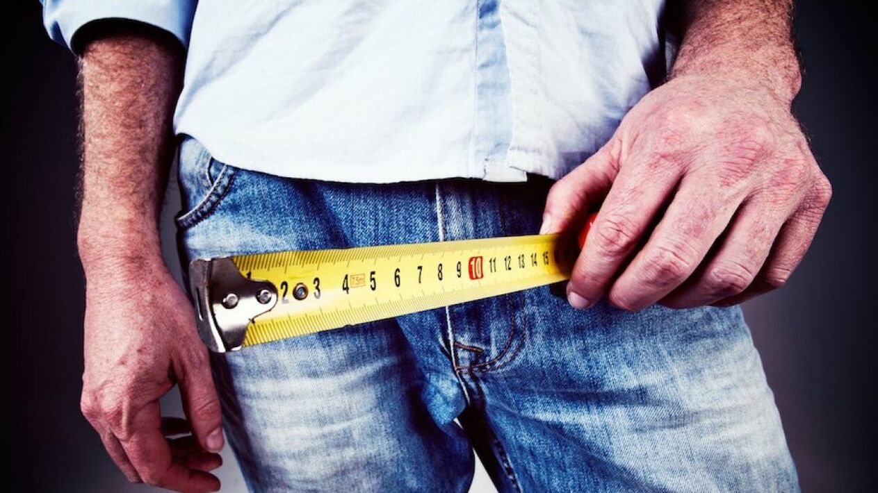 man measuring penis before enlargement